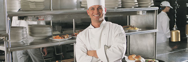 chef posing in a work kitchen 