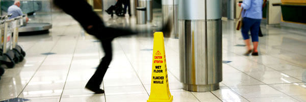 young man slipping on wet floor