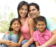 Happy latin family outside their home